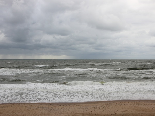 coast with white waves and cloudy