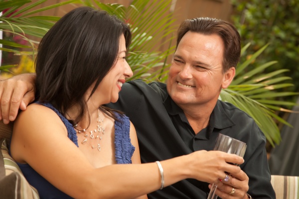 attractive hispanic and caucasian couple drinking