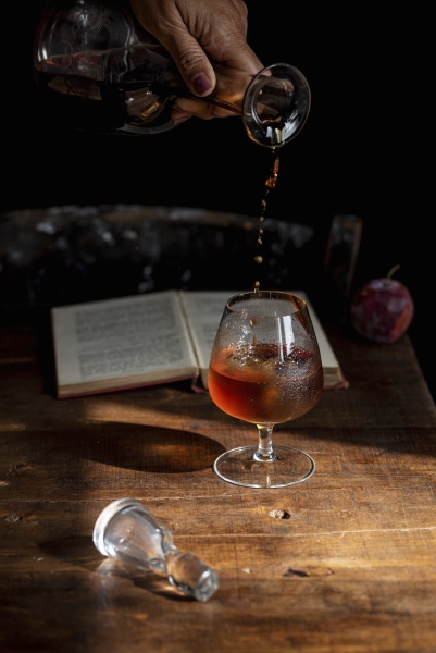 pouring cognac from decanter into glass