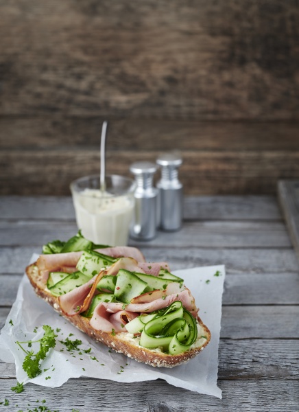 baguette topped with cucumber and bacon