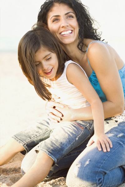 mixed race mother holding daughter in