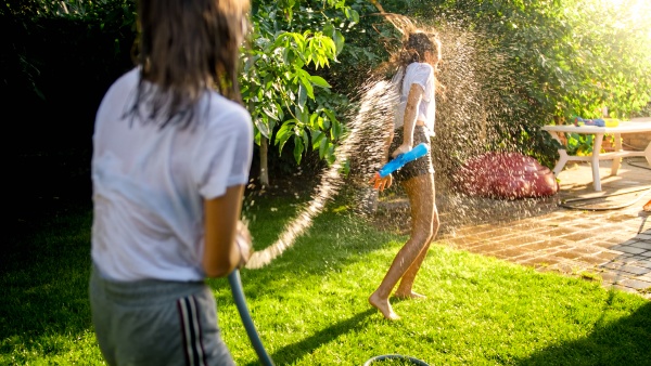 two teenage girls playing water fight