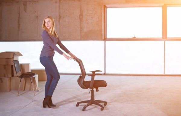 business woman pushing office chair