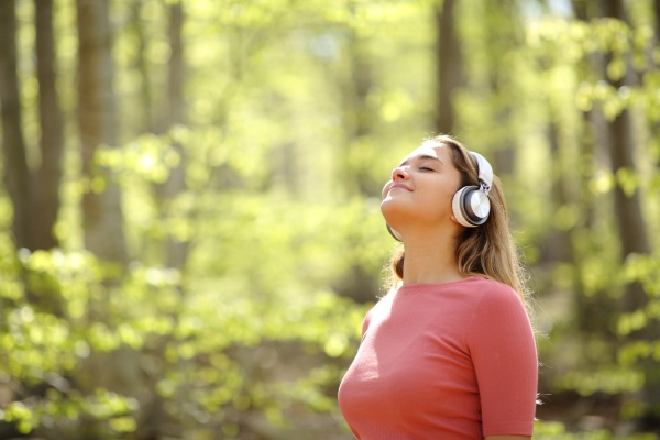 woman meditating wearing headphones in a