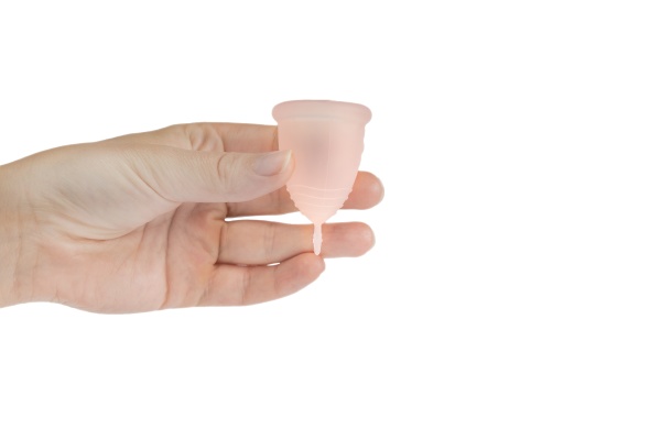 womans hand holding menstrual cup