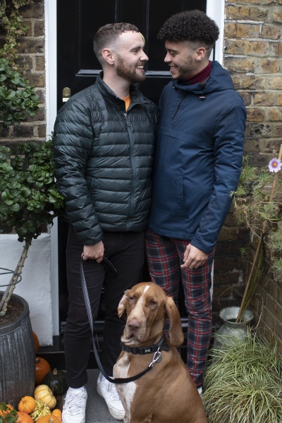 happy gay male couple with dog
