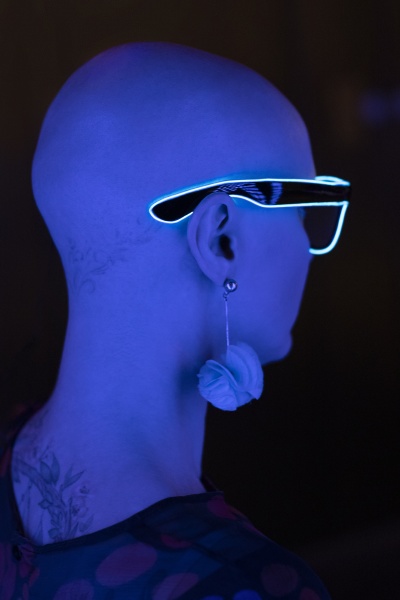 stylish woman with shaved head wearing