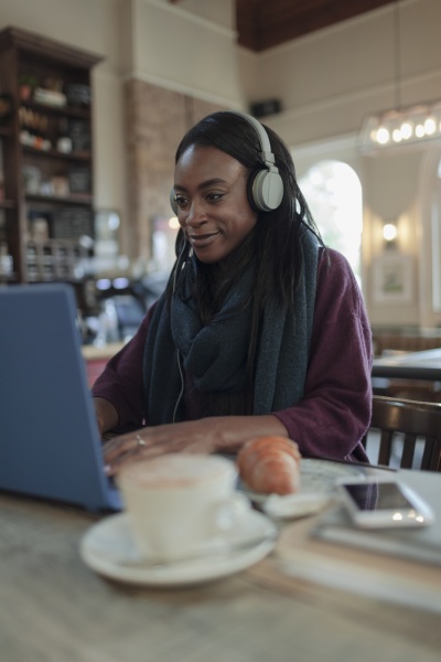 young woman with headphones working at
