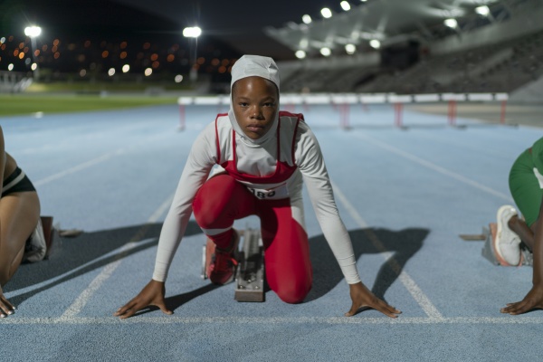 portrait determined female runner in hijab
