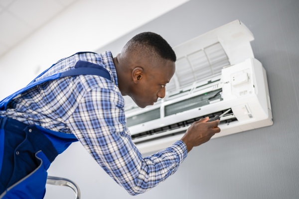 ac electrician technician repairing air conditioner