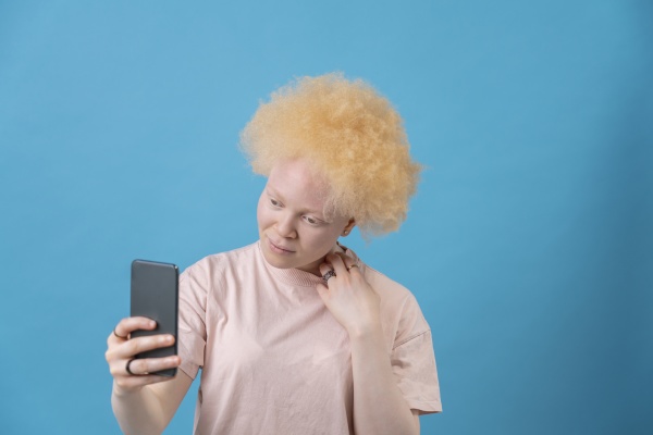 studio shot of albino woman holding