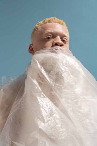 studio portrait of albino man wrapped