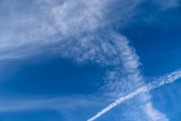 aircraft condensation contrails in the blue