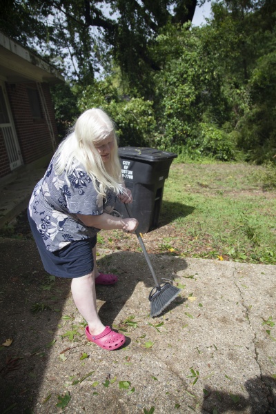 woman cleaning a yard