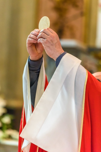 priest giving eucharist
