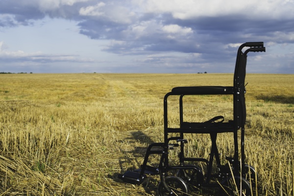 empty wheelchair in a wide meadow