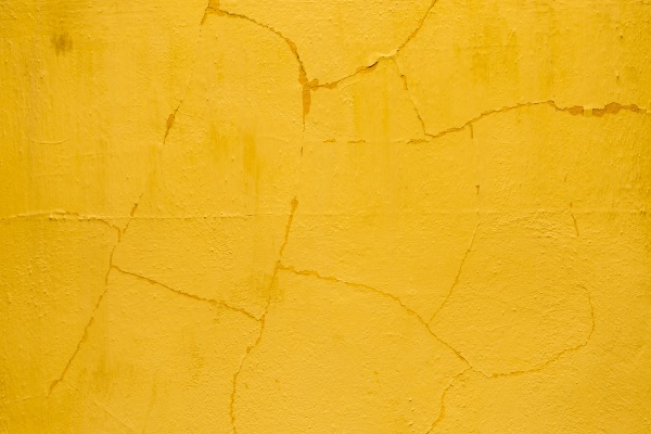 old cracked orange plaster wall