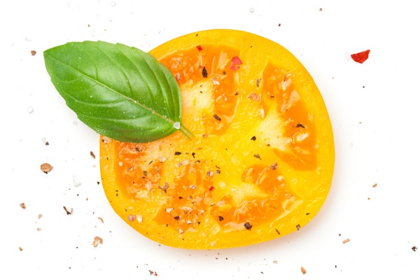 yellow tomato slice with basil and