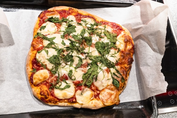 homemade pizza with sliced mozzarella cheese