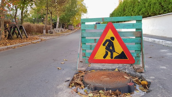 road repair sewer manhole on