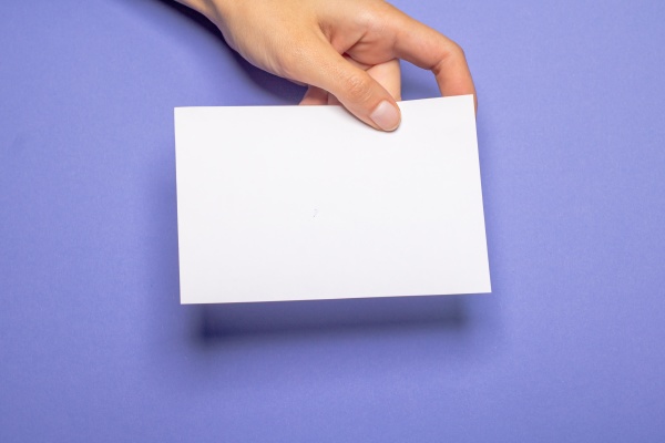 woman holding blank letter on violet