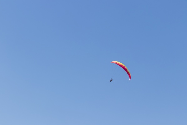 colorful parachute aviator with blue sky