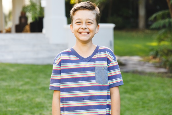 portrait of smiling caucasian boy outside