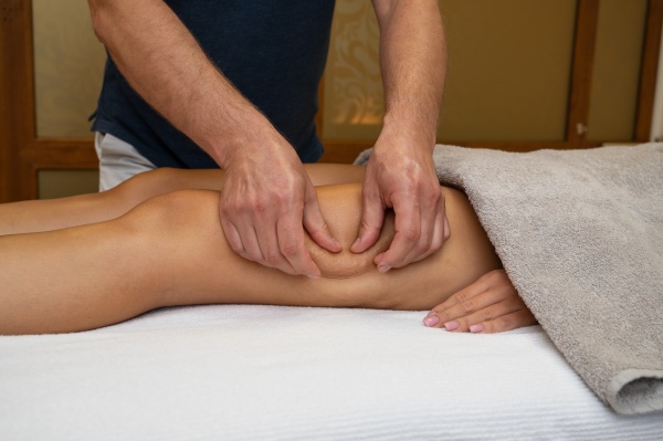 woman getting legs massage in spa