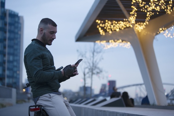 man using smart phone in city