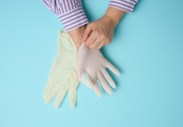 process of putting white latex gloves