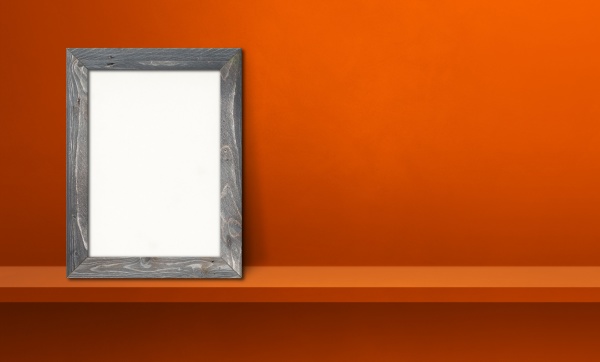 wooden picture frame leaning on orange