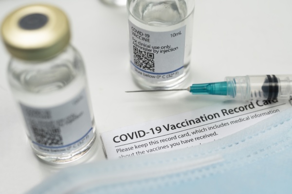 syringe on covid 19 vaccination record