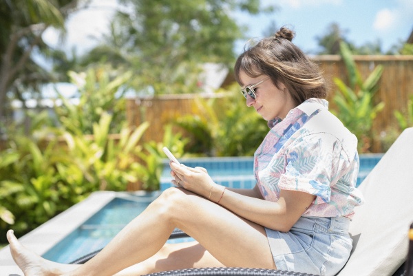 woman using smart phone on sunny