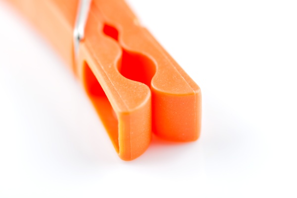 a orange clothepin in closeup