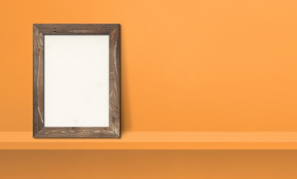 wooden picture frame leaning on orange