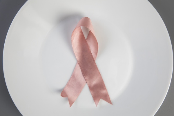 pink ribbon on white plate with
