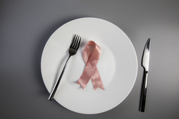 pink ribbon on white plate with