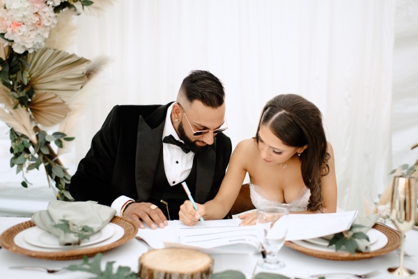 bride and groom signing their marriage