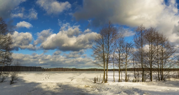 white clouds over a frozen lake