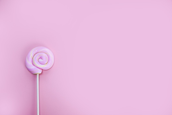 colorful spiral lollipop on pink background