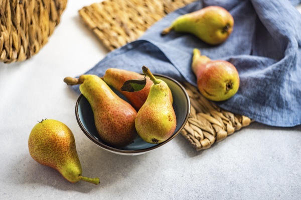organic ripe pears in ceramic bowl