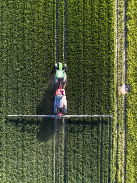 aerial view tractor spraying lush green