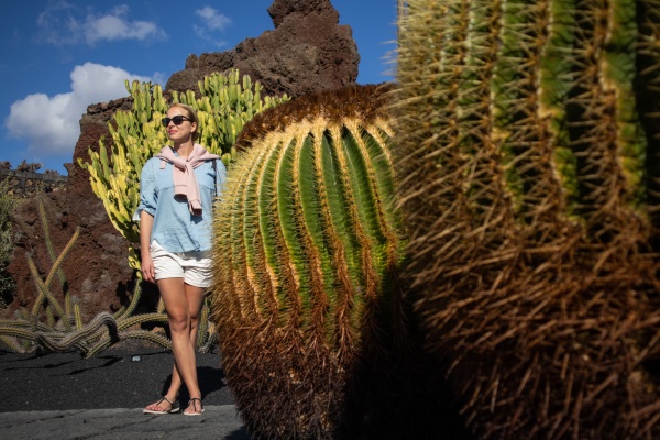 female tourist sightseeing at tropical cactus