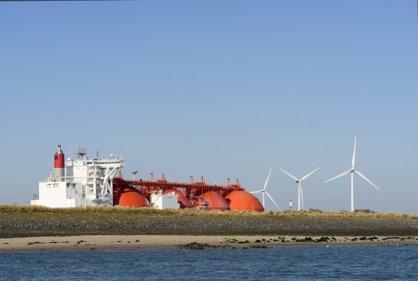 industrial ship and wind turbines at