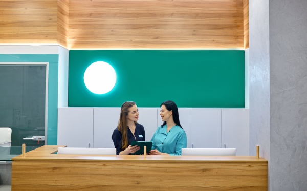 two female doctors working at reception