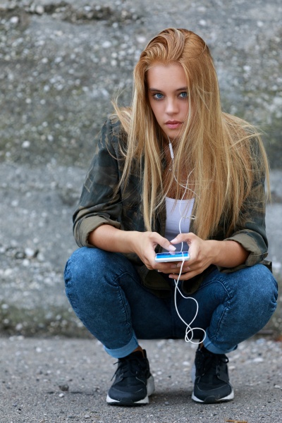 beautiful blonde girl listening music with
