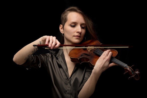 passionate woman violinist playing classical music