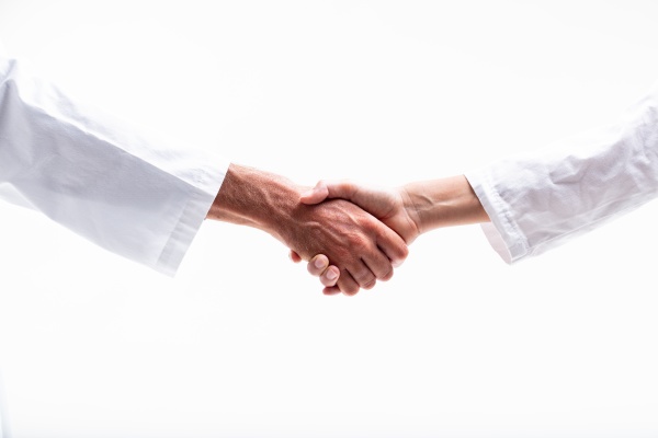 male and female doctors shaking hands