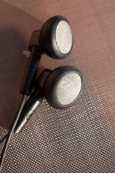 black anonymous earphones on a metallic