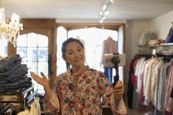 female shop owner vlogging with smart
